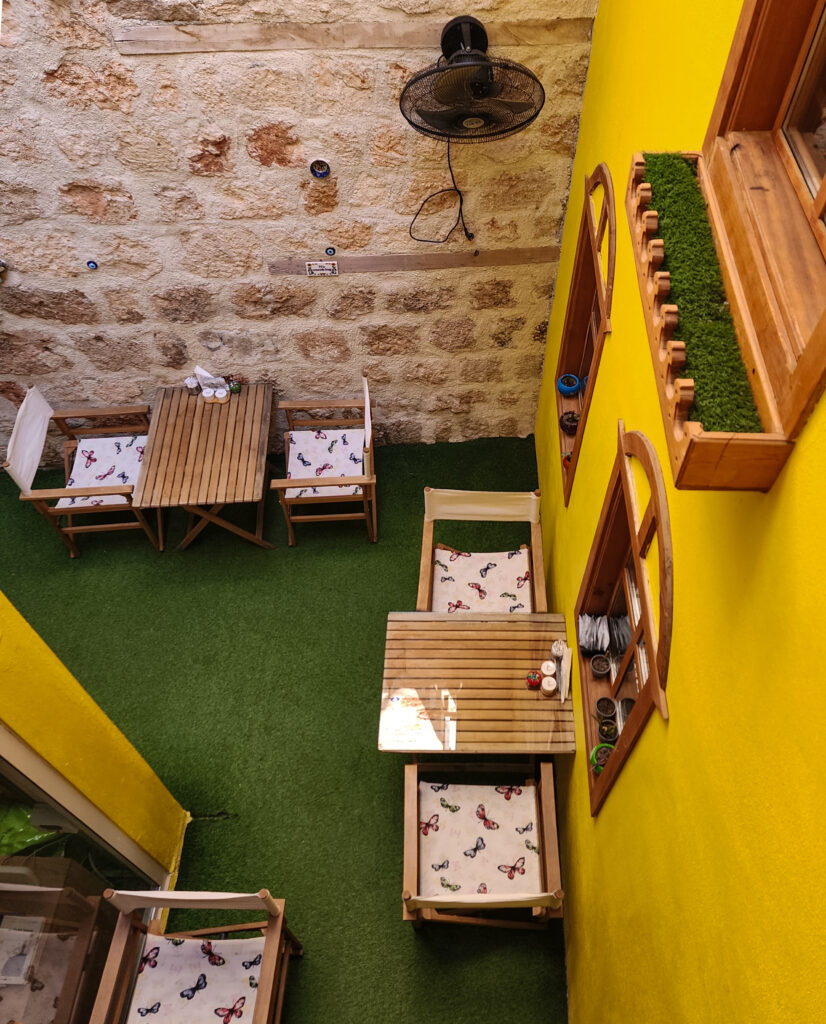 Stone wall and yellow stairs inside a Kaleici boutique hotel