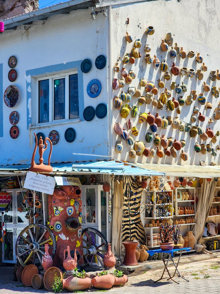 Blue and white wall decorated with ceramics and nazar amulets in Avanos