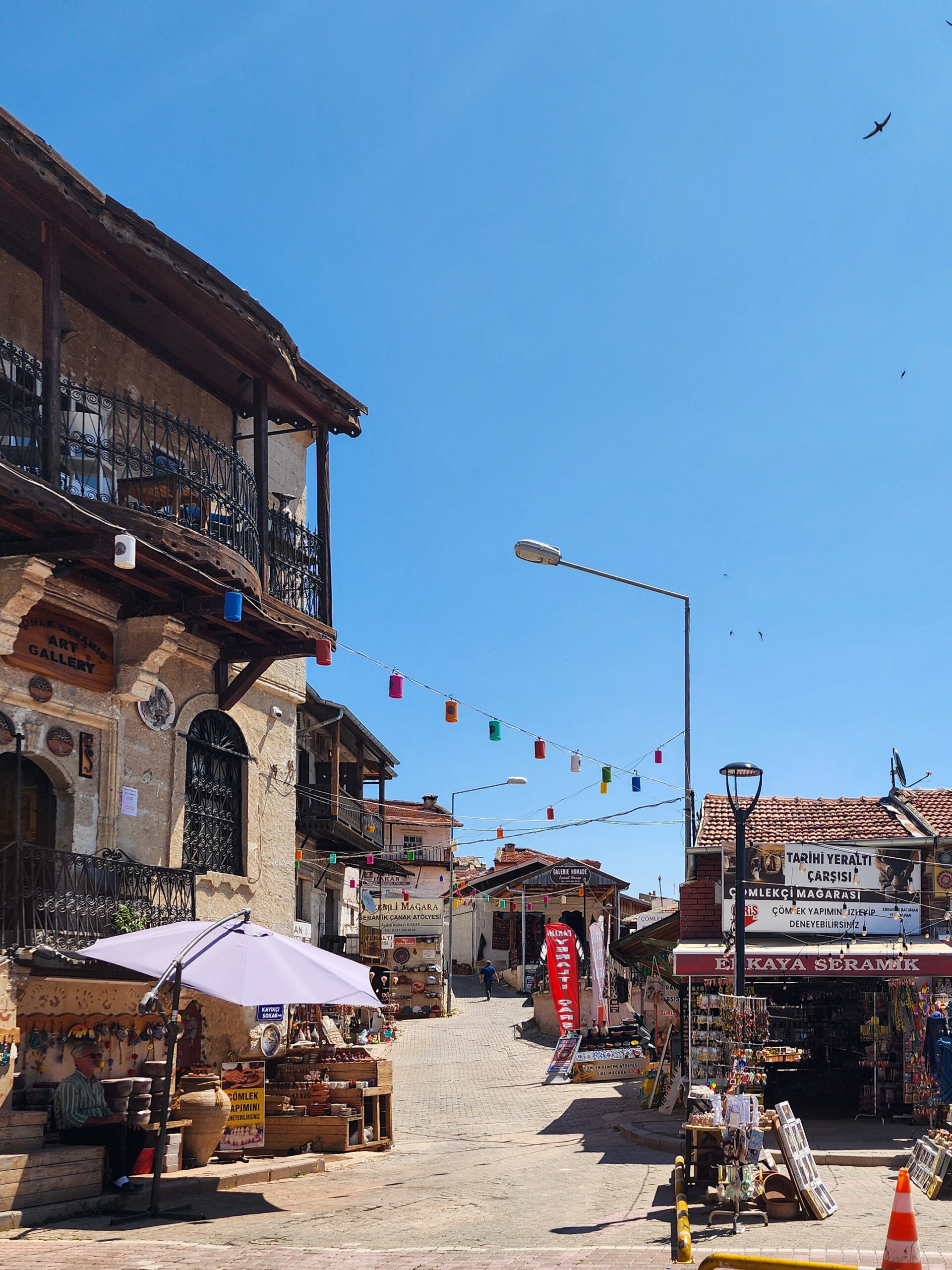 Traditional wooden and stone buildings on a street in Avanos