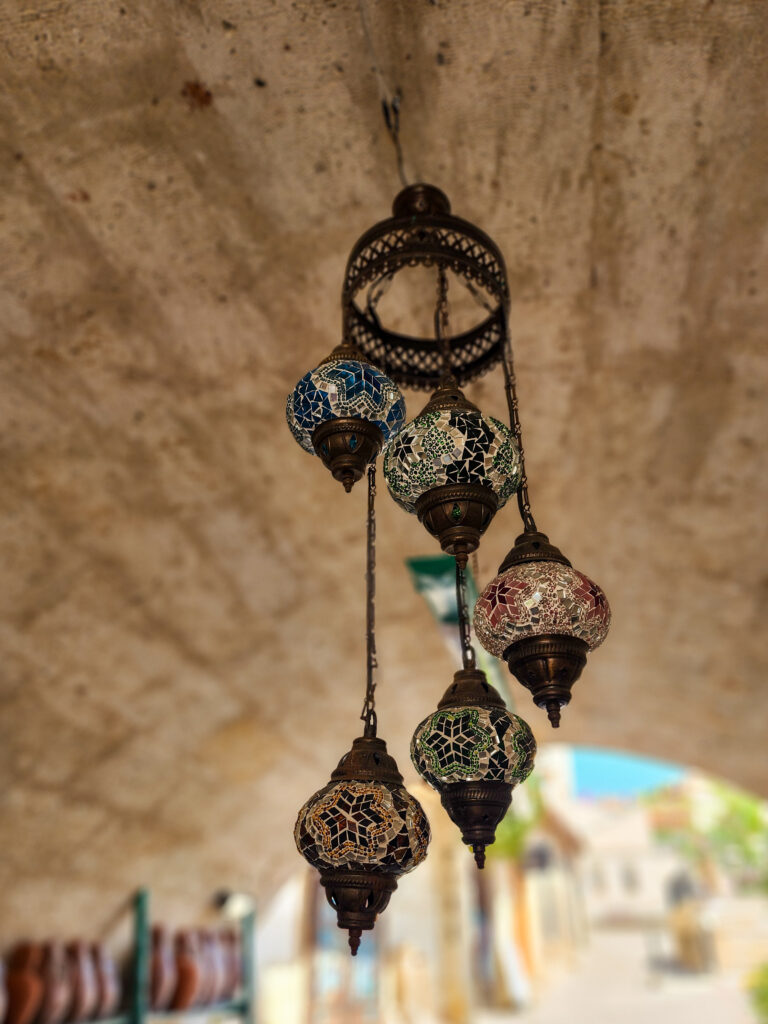 Pottery and ceramic decorations displayed on a stone wall in Avanos