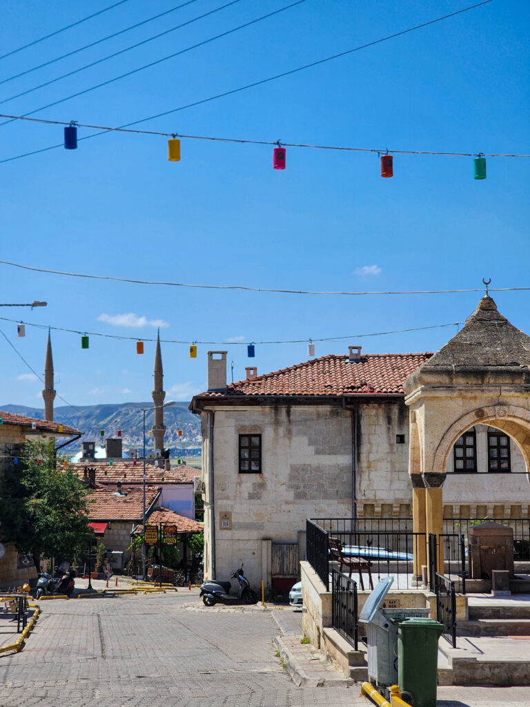 Mosque and minaret behind traditional buildings in Avanos