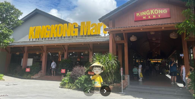 Storefront of KingKong Mart in Duong Dong, Phu Quoc, with its sign, covered walkway, and a mascot figure out front