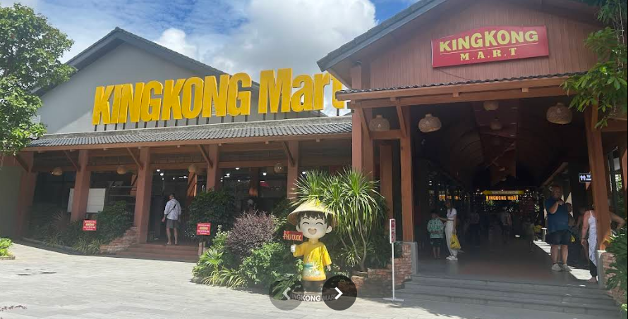 Storefront of KingKong Mart in Duong Dong, Phu Quoc, with its sign, covered walkway, and a mascot figure out front
