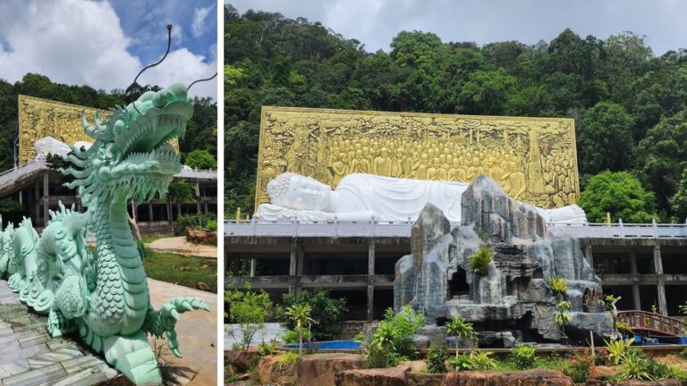 Large white reclining Buddha statue in front of a giant golden relief mural of Buddha figures, backed by jungle-covered hills, with a jade dragon statue in the foreground at Su Muon Pagoda