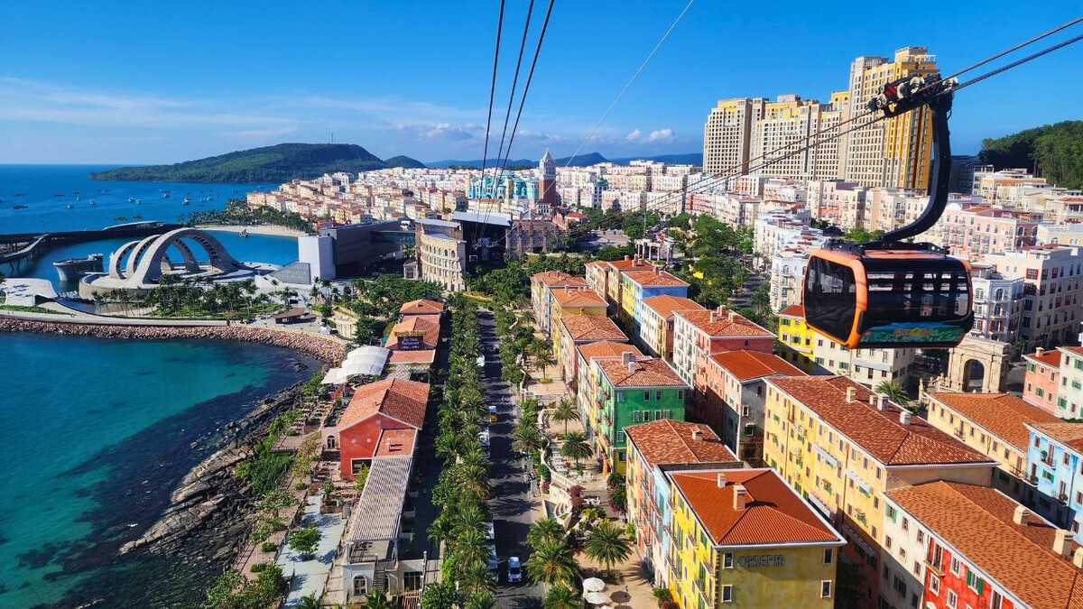 Aerial view from the Hon Thom cable car looking down over the colorful buildings and Kiss Bridge amphitheater of Sunset Town, Phu Quoc