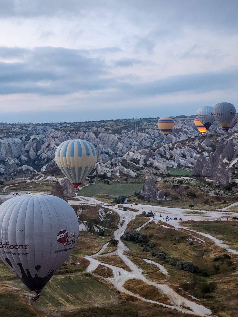 Hot air balloons flying over Göreme at sunrise