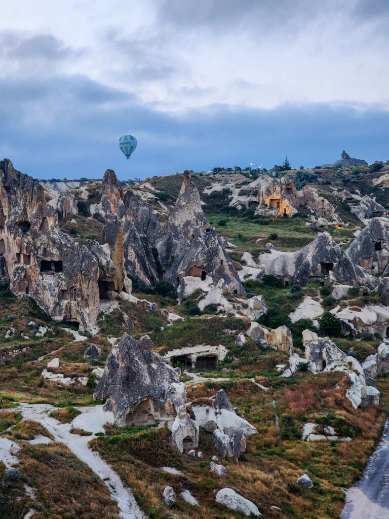 Aerial overview of where to stay in Göreme, with town and hillside hotels at sunrise
