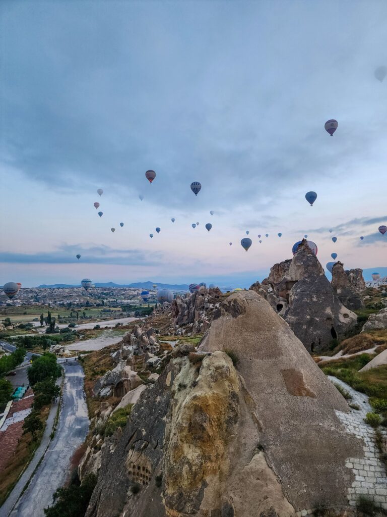 Hot-air balloons floating above Göreme at sunrise in Cappadocia