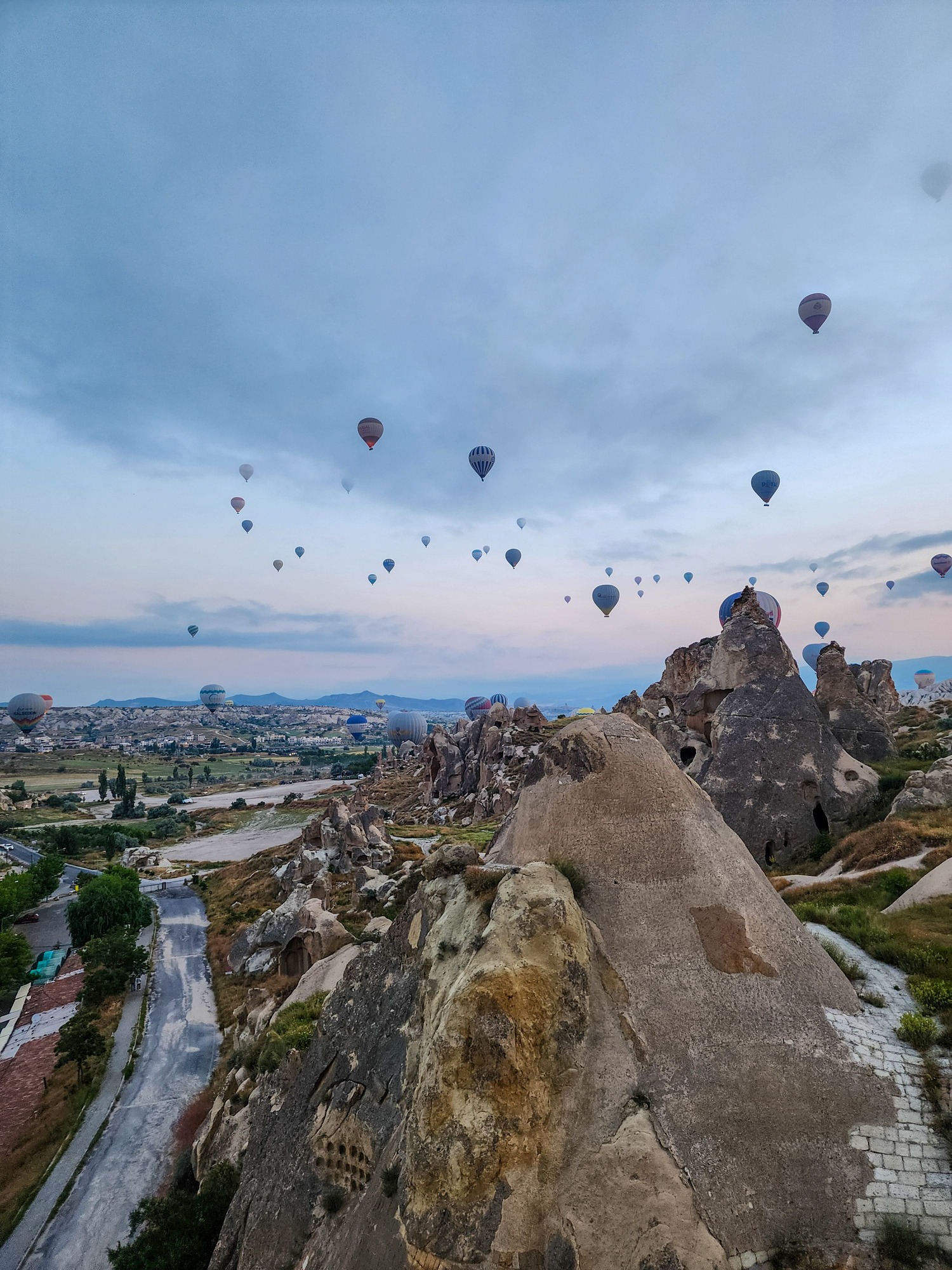 Hot-air balloons floating above Göreme at sunrise in Cappadocia