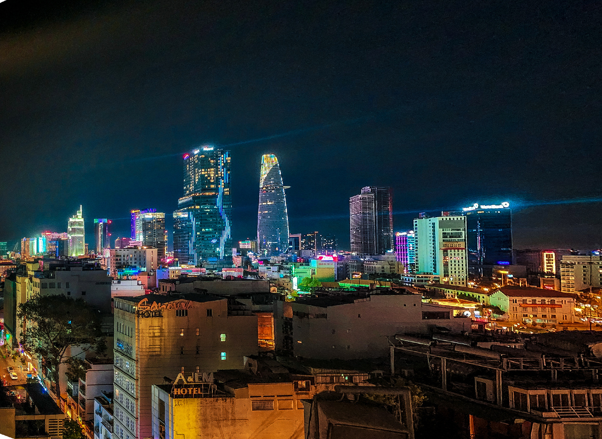 Ho Chi Minh City skyline illuminated at night across the river