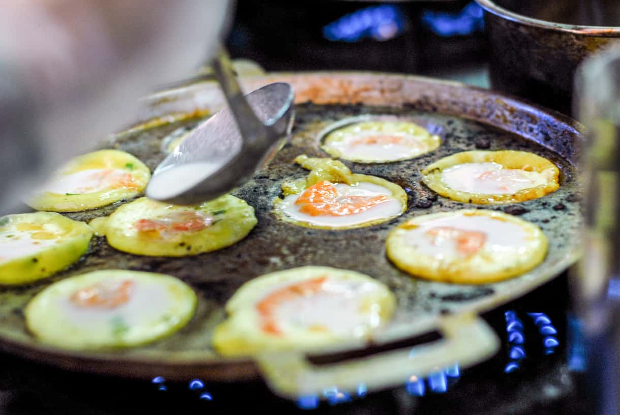 Banh khot rice pancakes cooking in a street-food pan